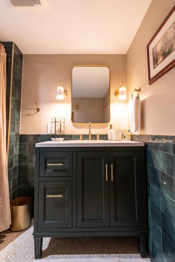 Green vanity with brass mirror and two sconces