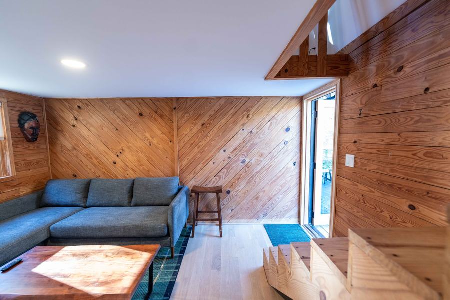 Diagonal pine paneling and the glass door to the deck